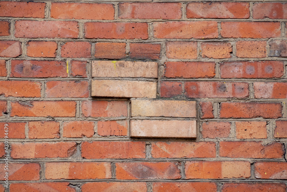 Fototapeta premium The texture of a fragment of a brick wall with a four-sided rectangular projection
