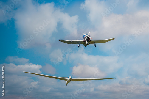 a single engine plane towing a sailplane glider at takeoff