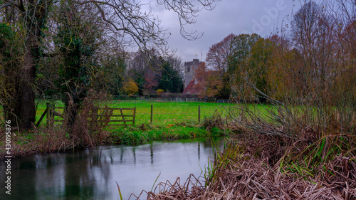 Autumn view of the river Meon with St Mary's and All Saints' Church, Droxford, Hampshire, UK
