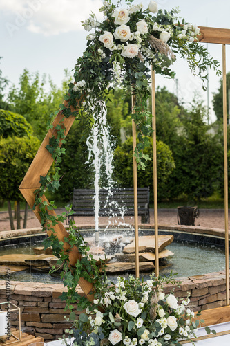 Close up of wedding eco decor with white fresh white flowers on wood arch