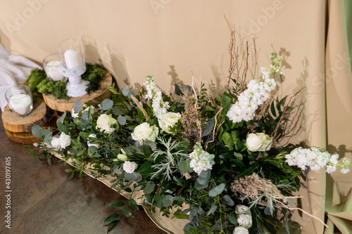 Close up of wedding ceremony with arch in rustic style with fresh flowers