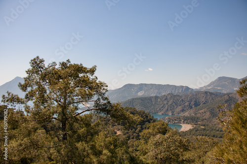 beautiful view of green trees on hills and sea bay and clear blue sky