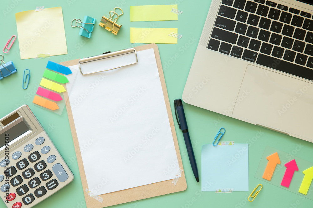 Work space with calculator, post-it, keyboard and Paper clip for financial report. Desktop modern business person. Accounting concept. green background. Work space with calculator, post-it, keyboard and Paper clip for financial report. Desktop modern business person. Accounting concept. green background.