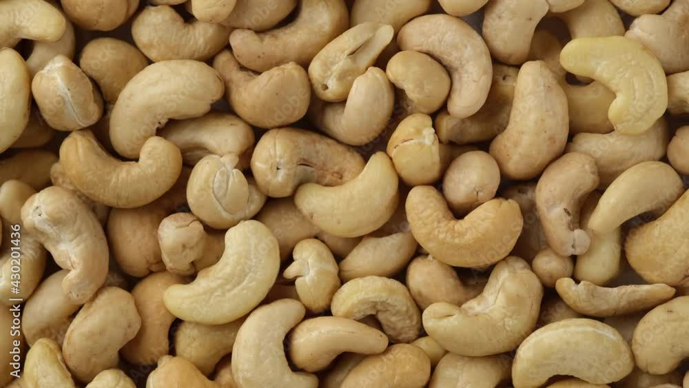 raw cashew nuts top view. Sliding shot. 4K UHD video raw cashew nuts top view. Sliding shot. 4K UHD video
