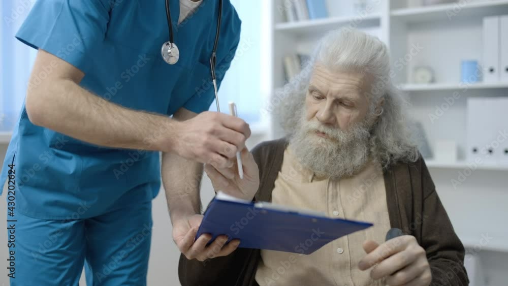Medical worker asking senior man to sign document, health insurance, service Medical worker asking senior man to sign document, health insurance, service