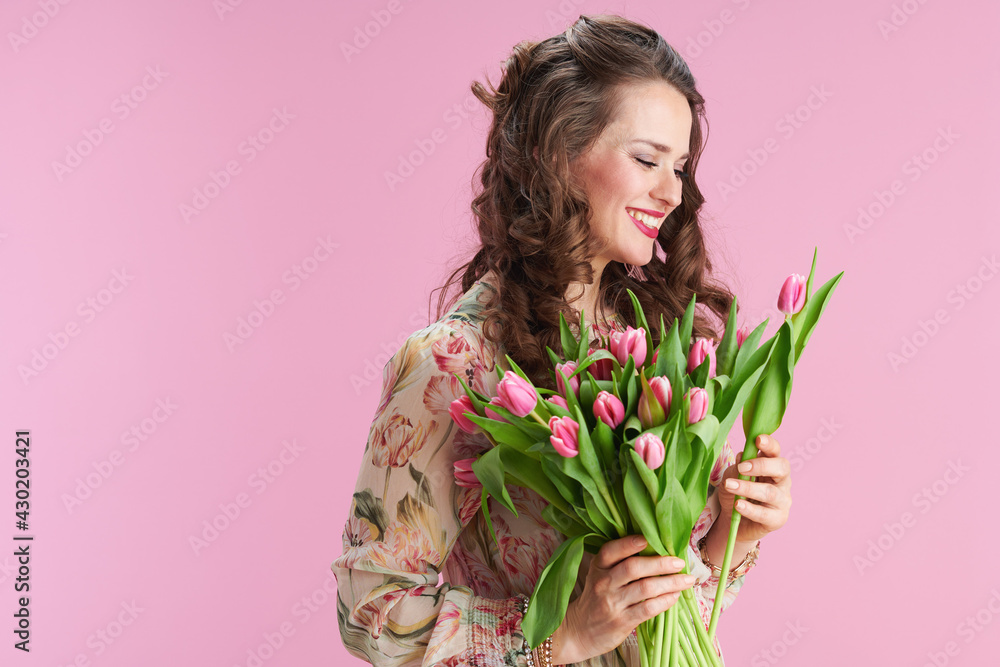 smiling trendy woman in floral dress on pink smiling trendy woman in floral dress on pink