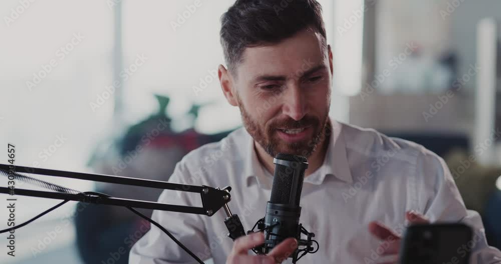 Man podcasting at home studio apartment. Young caucasian radio host recording podcast video talking with audience communicating online. Lockdown. Man podcasting at home studio apartment. Young caucasian radio host recording podcast video talking with audience communicating online. Lockdown.