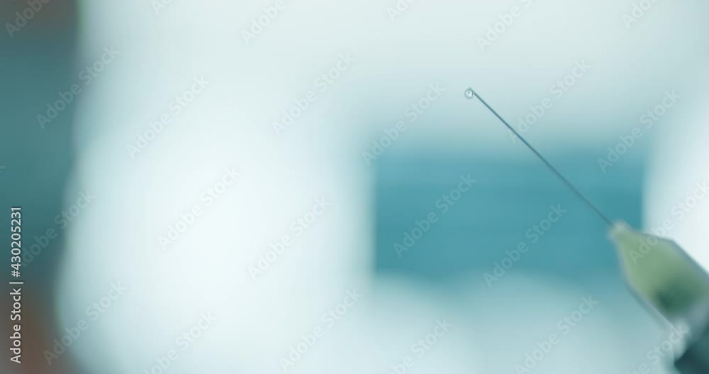 Close-up a dental needle with liquid. Close-up a dental needle with liquid.