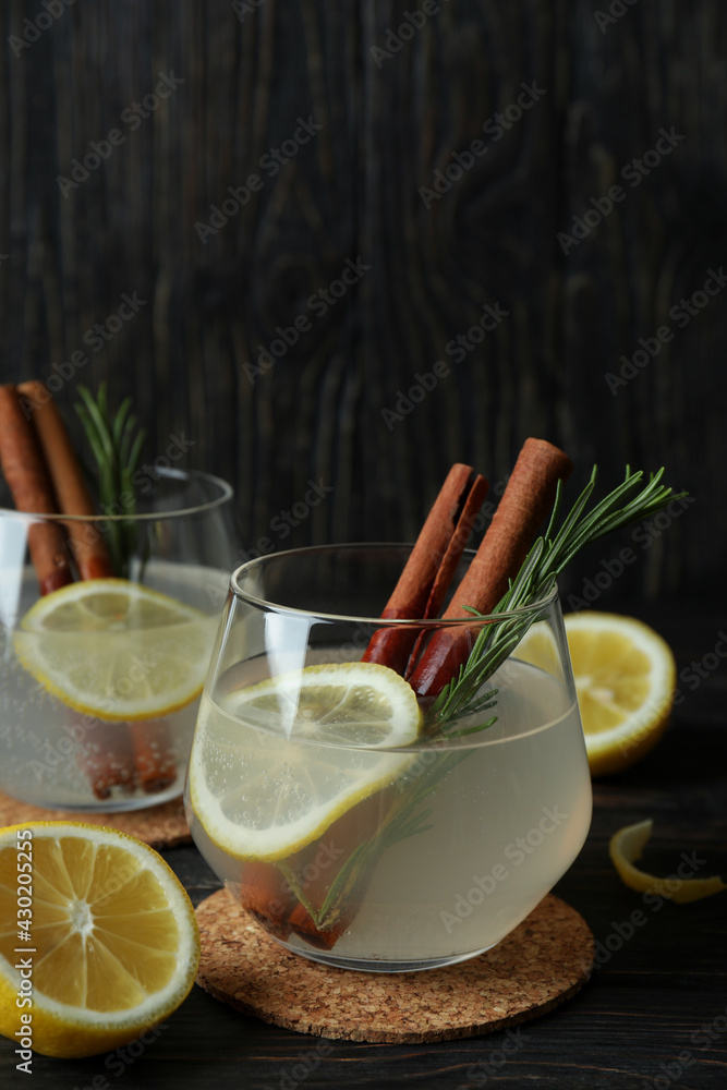 Fototapeta premium Glasses of lemonade on wooden background, space for text