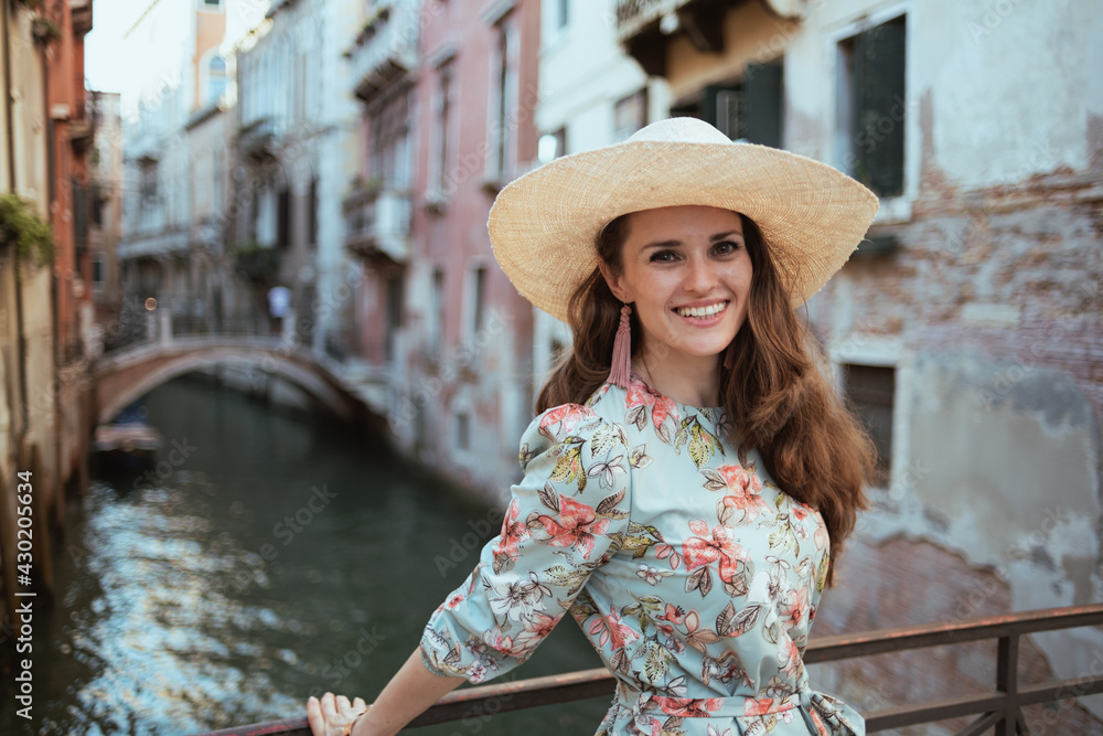 smiling elegant traveller woman in floral dress sightseeing