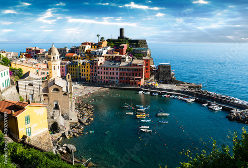 Vernazza,Liguria,Italy. June 2020. A viewpoint from the top of the hill towards the seaside village. The colorful houses stand out. People bathe in the waters of the marina. Famous tourist destination