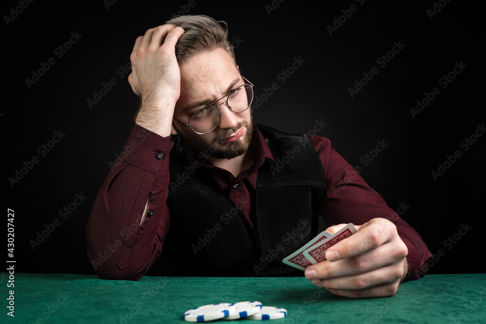 The poker player does not succeed. He lost almost everything. He has the last chips on the table.