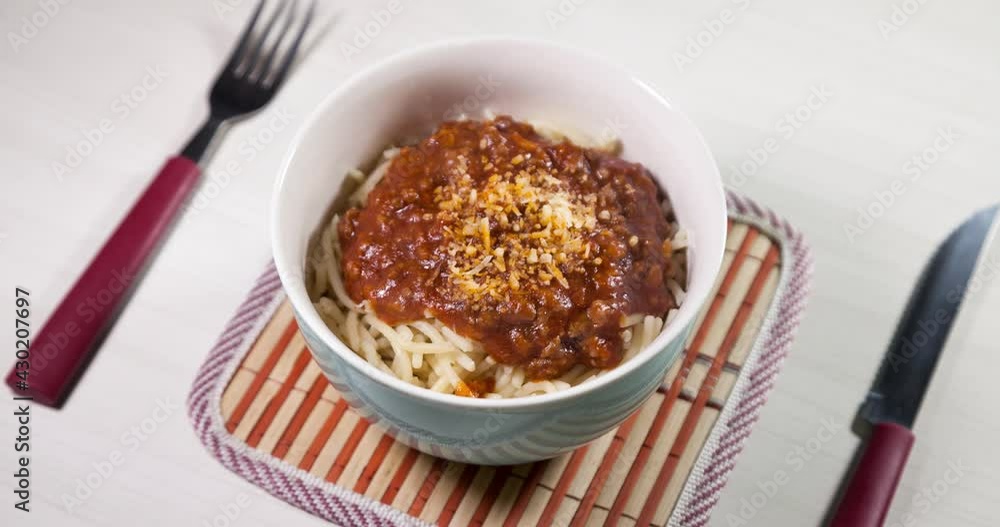 Bowl of spaghetti pasta in bolognese sauce with grated cheese placed on the table. Ready to eat and with copy space. Food concept. Pasta concept.
Bowl of spaghetti pasta in bolognese sauce with grated cheese placed on the table. Ready to eat and with copy space. Food concept. Pasta concept.