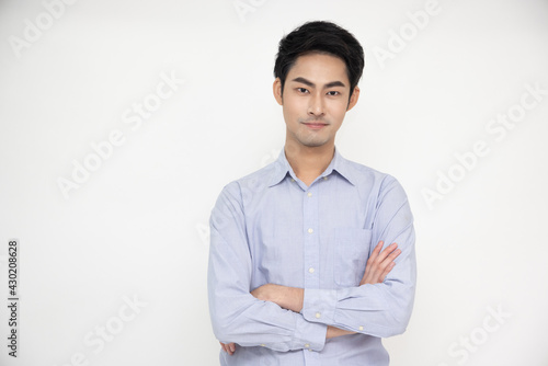 Portrait of Asian man with arms crossed and smile isolated over white background