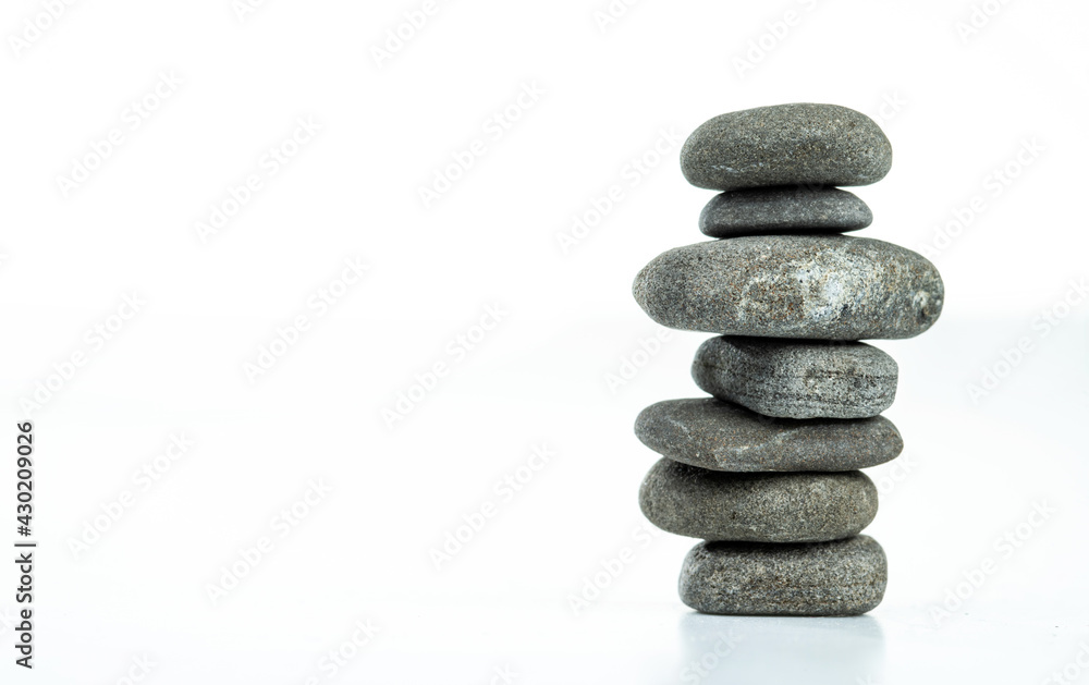 Pebble pyramid in balance are isolated on a white background. Stones pyramid symbolizing zen, harmony, balance. Pebble pyramid in balance are isolated on a white background. Stones pyramid symbolizing zen, harmony, balance.
