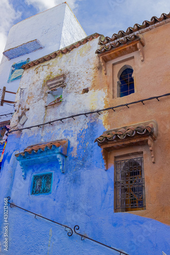 Fragment of the facade of a partially painted building in Medina of the Chefchaouen, Morocco. Part of the wall has not yet been painted with blue paint. Blue pearl in the mountains of North Africa © Вера Тихонова