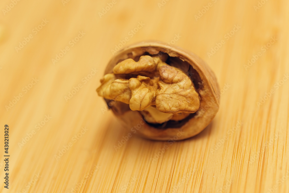 Fototapeta premium half-opened walnut lies on the table. Top view