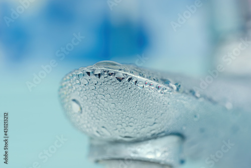 water drops on the faucet in the bathroom. Macro photo