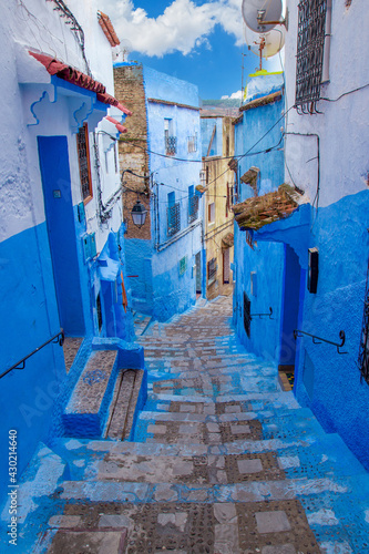 Narrow lane with steps in the blue medina of the Chefchaouen, Morocco. Blue city with traditional architecture in the Rif mountains of North Africa. © Вера Тихонова