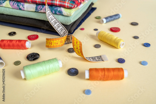 sewing accessories. sewing equipment on a yellow background