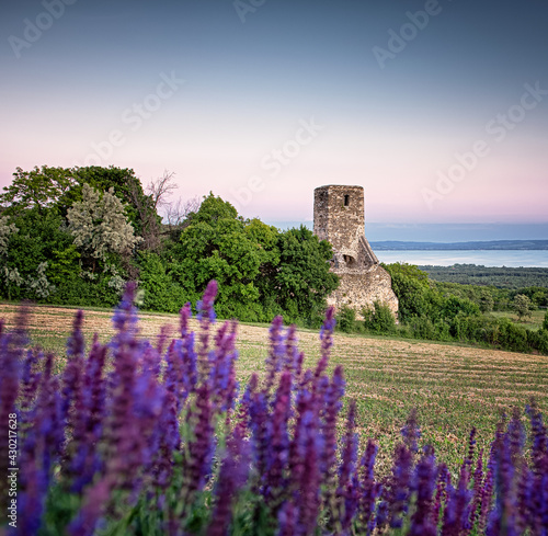 Sunset over the medieval ruins of a temple at lake Balaton, Hungary