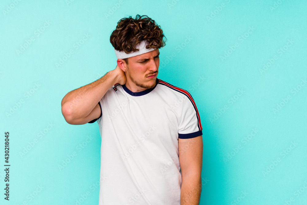 Young sport caucasian man isolated on blue background suffering neck pain due to sedentary lifestyle. Young sport caucasian man isolated on blue background suffering neck pain due to sedentary lifestyle.