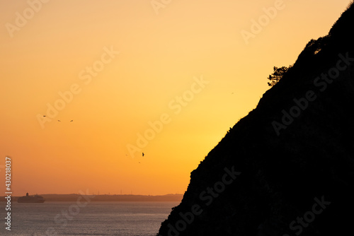 Beautiful poster art landscape image of setting sun against silhouette landscape