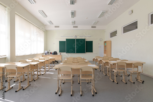 empty school class before final exams. Sheets for tests are laid out on the desks. overall plan