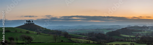 Beautiful vibrant sunrise panoramic landscape image of Colmer's Hill in Dorset on a Spring morning