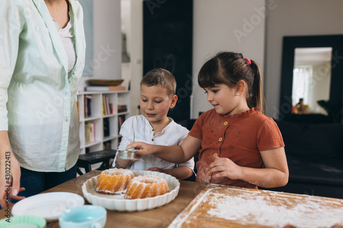 children baking with their mother at home