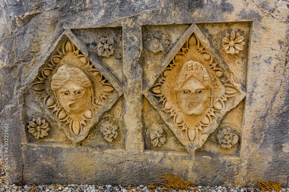 Stone faces bas relief at the Myra ancient city. Demre, Turkey