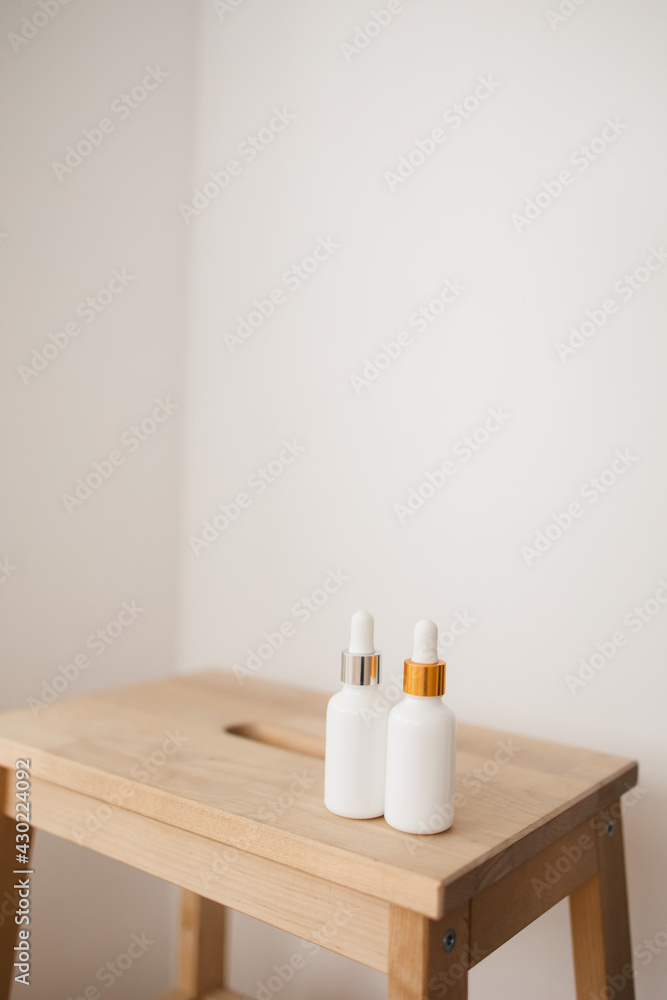 two white bottle with dropper cap. The concept of beauty. Cosmetics for home care. two white bottle with dropper cap. The concept of beauty. Cosmetics for home care.