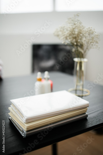 a stack of three books on a black table.