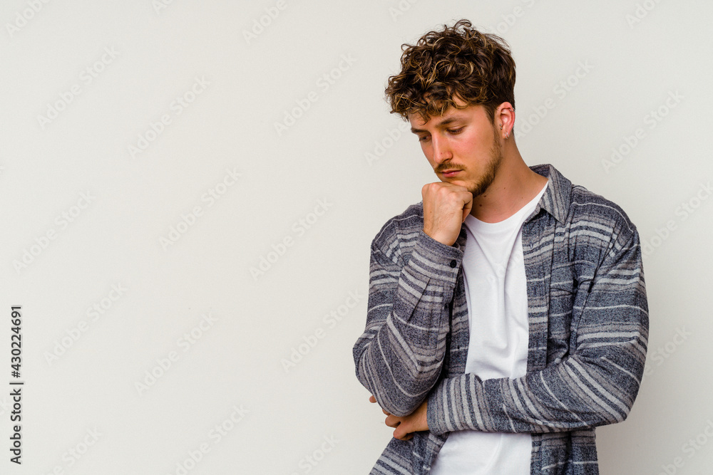 Young caucasian man isolated on white background looking sideways with doubtful and skeptical expression. Young caucasian man isolated on white background looking sideways with doubtful and skeptical expression.
