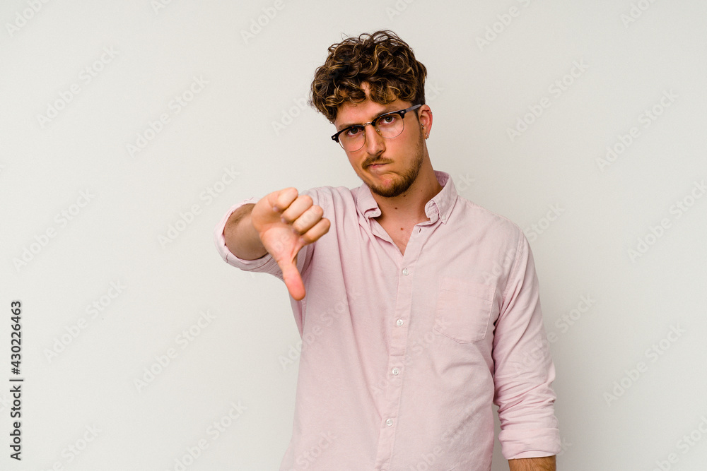 Young caucasian man isolated on white background showing thumb down, disappointment concept. Young caucasian man isolated on white background showing thumb down, disappointment concept.