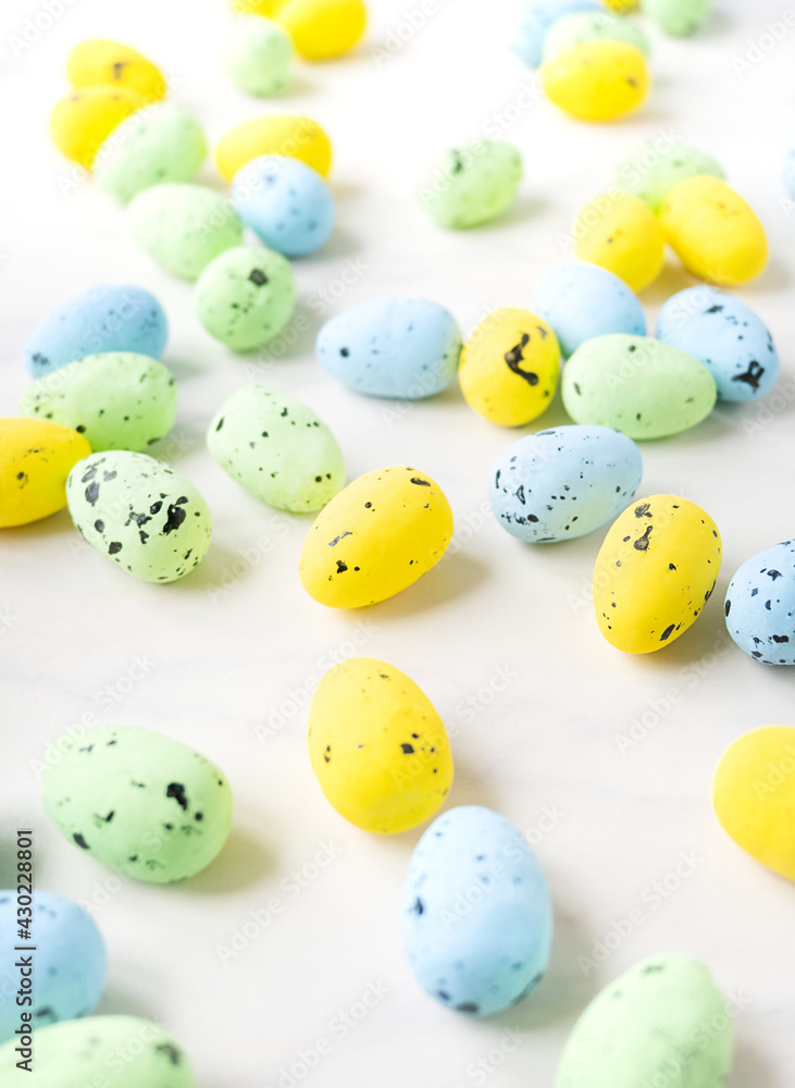 many colorful Easter quail eggs. soft pastel background