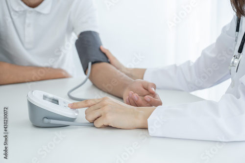 The doctor woman hand use the pulse meter to measure the pressure of the patient, medical checkup concept