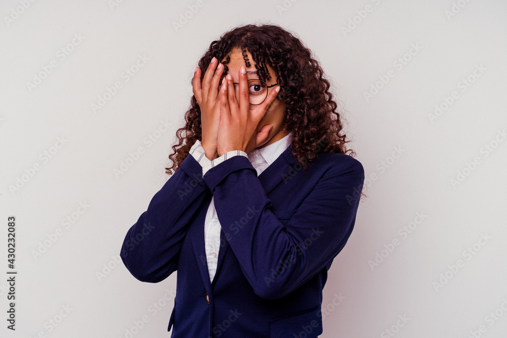 Young business mixed race woman isolated on white background blink through fingers frightened and nervous. Young business mixed race woman isolated on white background blink through fingers frightened and nervous.