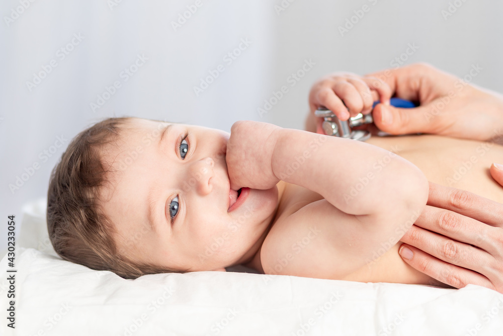 pediatrics, a doctor examines a baby boy and uses a stethoscope to listen to the baby's heartbeat or breathing, the concept of medicine and health pediatrics, a doctor examines a baby boy and uses a stethoscope to listen to the baby's heartbeat or breathing, the concept of medicine and health