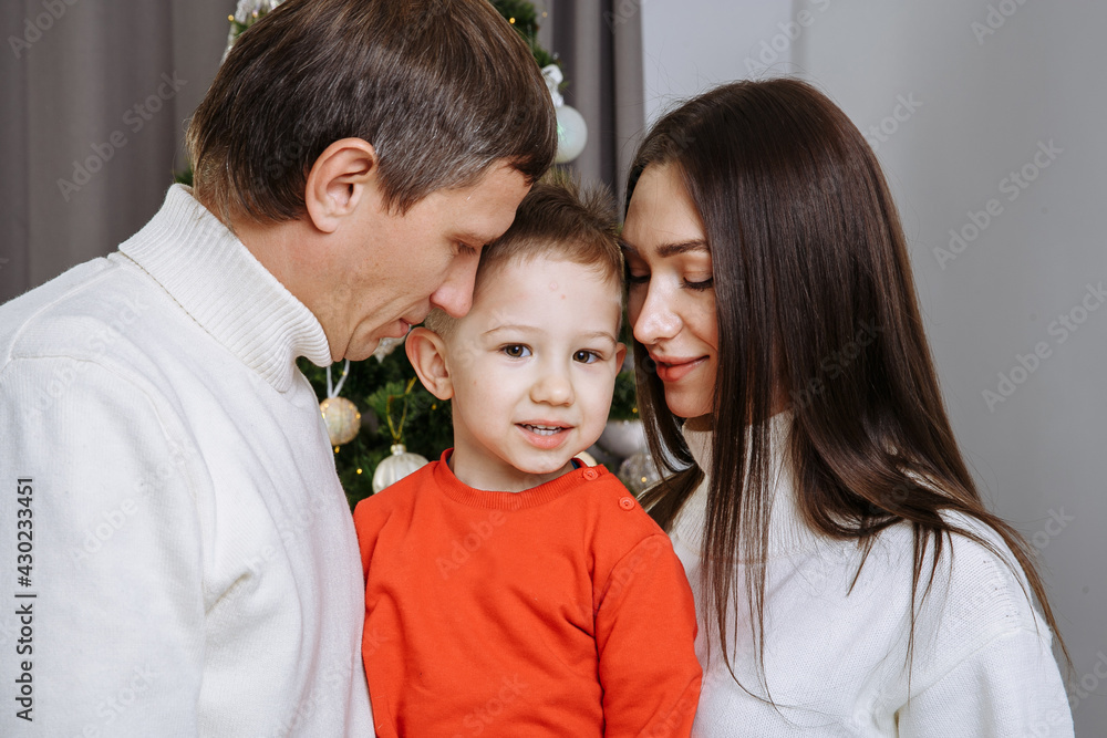 happy family on the background of the christmas tree happy family on the background of the christmas tree