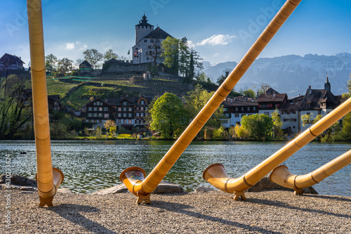 The alpine horns ensemble at the swiss lake and village of Werdenberg photo