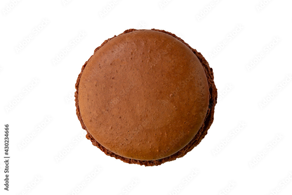One brown chocolate macaron cookie isolated on a white background. One brown chocolate macaron cookie isolated on a white background.