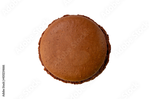 One brown chocolate macaron cookie isolated on a white background.