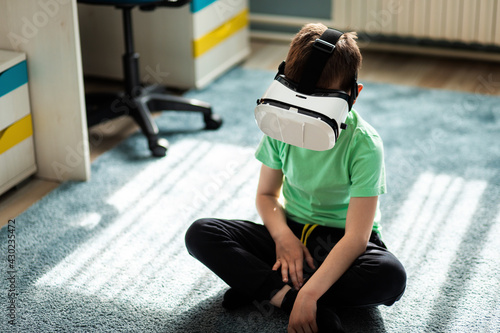 Little boy using virtual reality headset in his room.