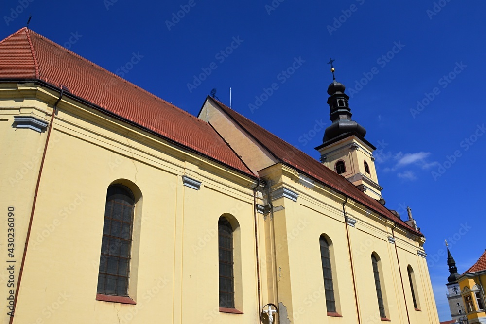 Southern wall and tower of early baroque Saint Jacob's church in Trnava, western Slovakia, also known as Franciscan church, known for its 13 altars inside. Summer daylight sunshine, blue skies. Southern wall and tower of early baroque Saint Jacob's church in Trnava, western Slovakia, also known as Franciscan church, known for its 13 altars inside. Summer daylight sunshine, blue skies.