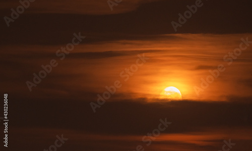 Moonset sky. Beautiful full moonset with brigt orange clouds. Sky background