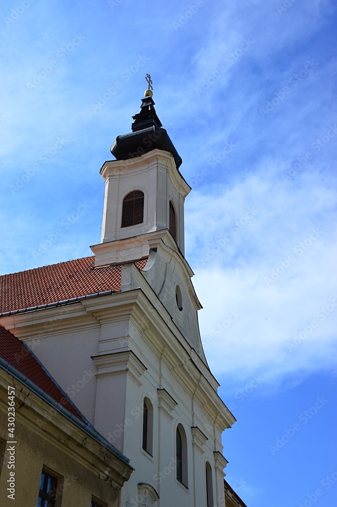 Northeastern view of tower o Saint Anne's Church in Trnava, western Slovakia, build in baroque style by order of Ursulines. Spring partially cloudy skies in background. 