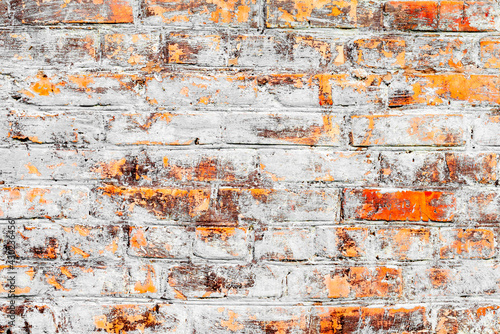 Texture of a brick wall with cracks and scratches which can be used as a background