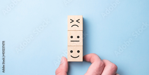 Wooden blocks with the happy face smile face symbol symbol on the table, evaluation, Increase rating, Customer experience