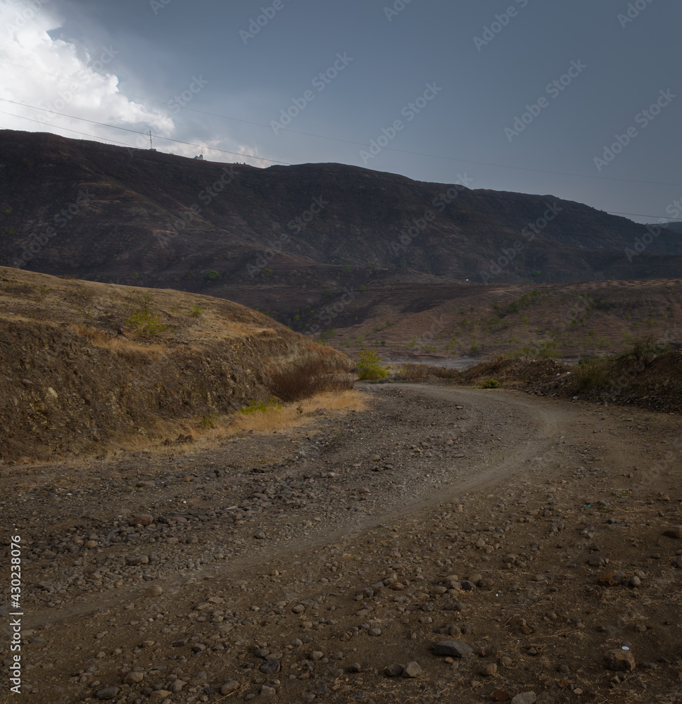Beautiful evening off road view from Kanifnath ghat at bopgoan , Pune. Road goes through connecting different mountains and hills Beautiful evening off road view from Kanifnath ghat at bopgoan , Pune. Road goes through connecting different mountains and hills